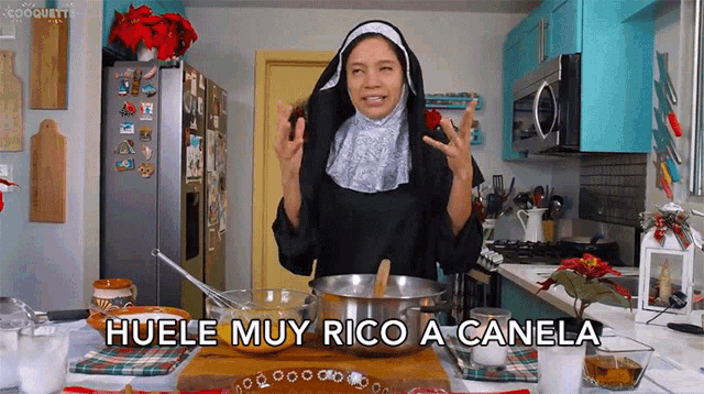 a woman in a nun costume is cooking in a kitchen with the words huele muy rico a canela below her