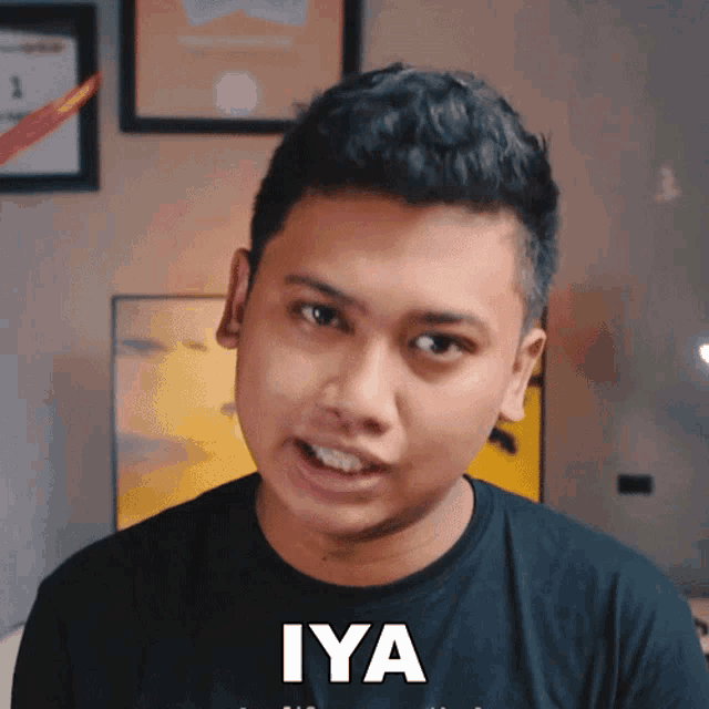 a man wearing a black shirt with the word iya written on it