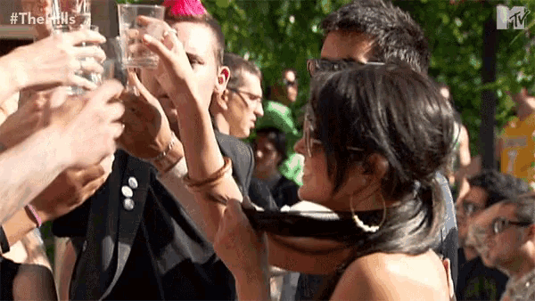 a group of people toasting with a sign that says #thehills