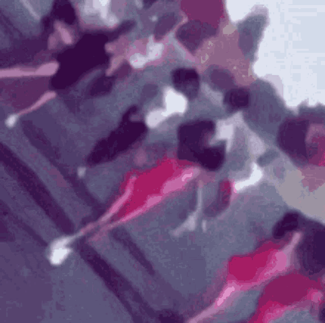 a blurred image of a group of people dancing in a dance studio