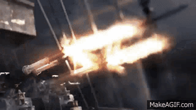 a close up of a gun with flames coming out of it on make a gif