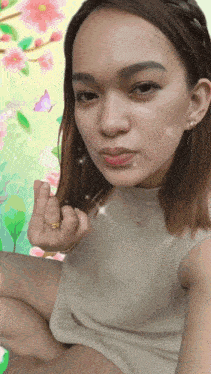 a woman wearing a white sweater and a gold ring is giving the middle finger