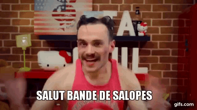 a man wearing a red tank top says salut bande de salopes