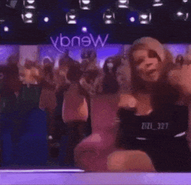 wendy williams is sitting in a chair in front of a crowd of people