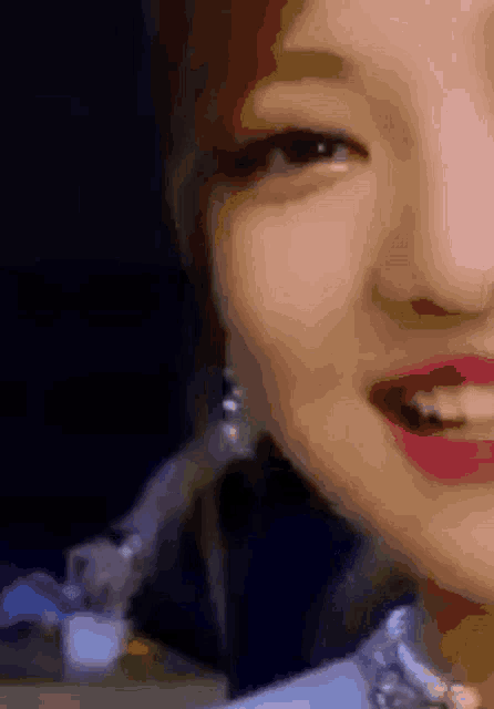 a close up of a woman 's face with a microphone behind her