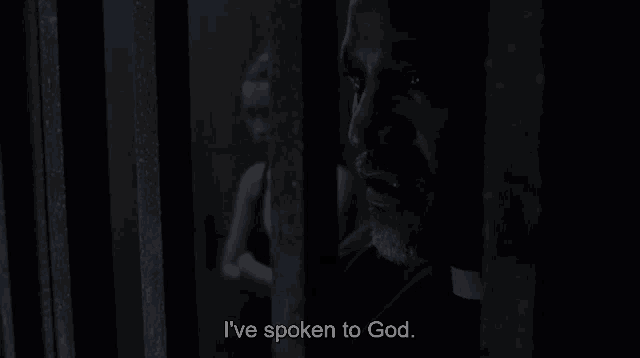 a man behind bars with the words he told me to hang you below him