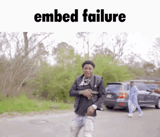 a man is walking down a street with the words embed failure behind him