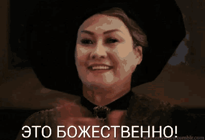 a woman wearing a black hat is clapping her hands in a foreign language