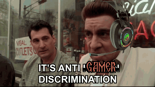 a man wearing a headset with the words " it 's anti gamer discrimination " on it