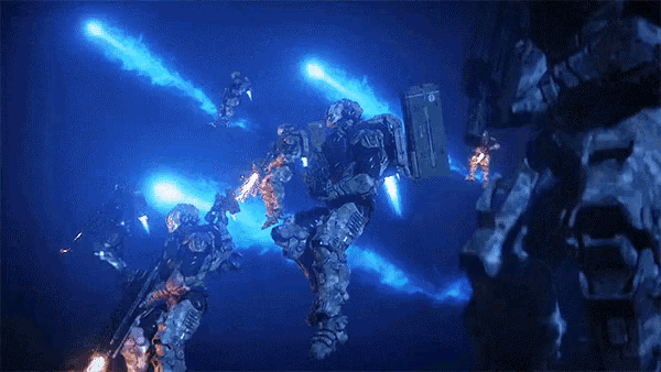 a group of soldiers are standing in a dark room with blue light coming from the ceiling