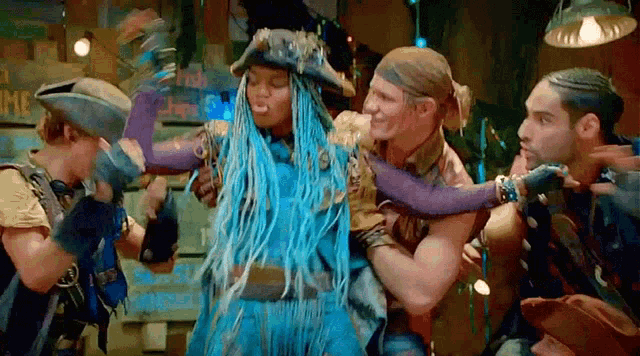 a group of men are holding a woman in their arms .