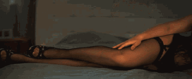 a woman in lingerie is laying on a bed and looking at the camera