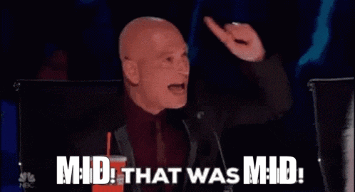 a man in a suit and tie is sitting in front of a microphone and saying `` mid that was mid '' .