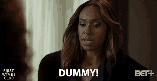 a woman says " dummy " in front of a bet + logo