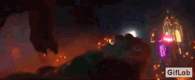 a blurry picture of a city at night with a giflab logo in the lower right corner