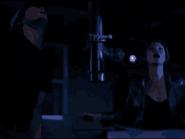 a man and a woman in a dark room with the words they 're all gone above them