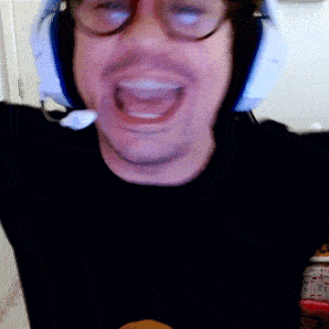 a man wearing glasses and a headset with his mouth open