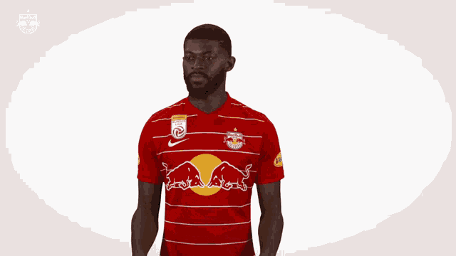 a man in a red and white striped shirt with a red bull on it
