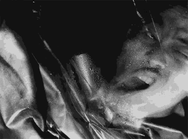 a black and white photo of a person 's face with water coming out of it