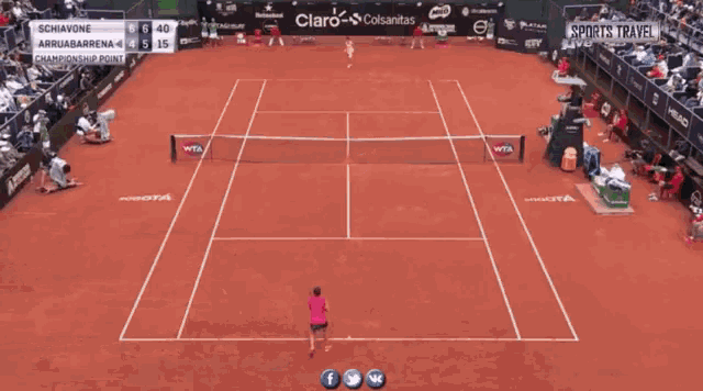 a woman in a pink shirt is holding a tennis racquet on a tennis court sponsored by playtex and heineken