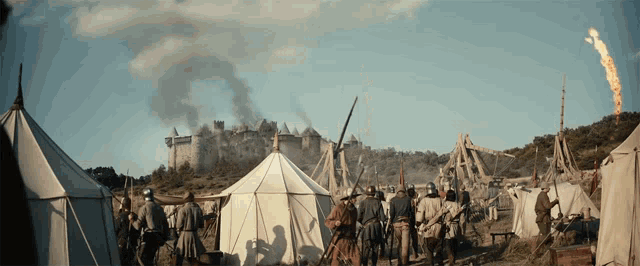 a group of soldiers are standing in front of a castle