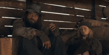 a man with a beard sits next to a woman