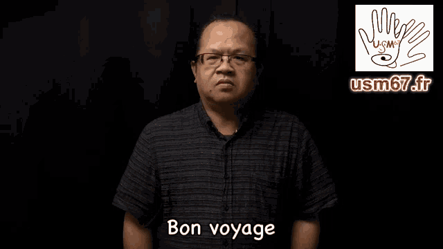 a man wearing glasses and a plaid shirt says bon voyage