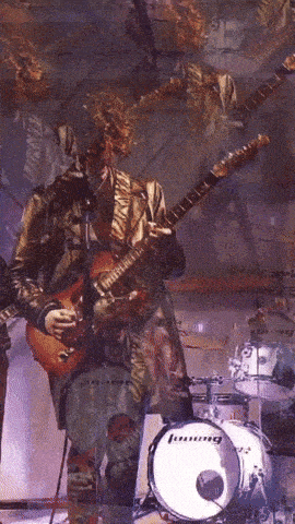 a person playing a guitar in front of a ludwig drum set