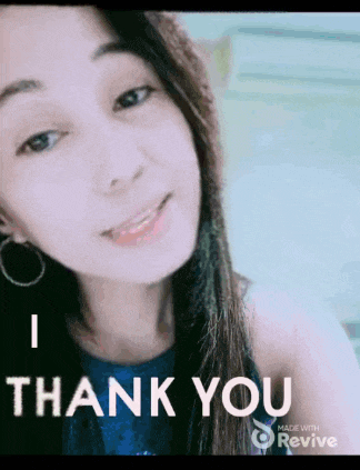 a woman is smiling and says thank you in a video .