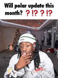 a man wearing headphones is sitting in a room with a christmas tree in the background