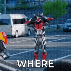 a man in a motorcycle suit is standing in a parking lot with the words where written on the ground .