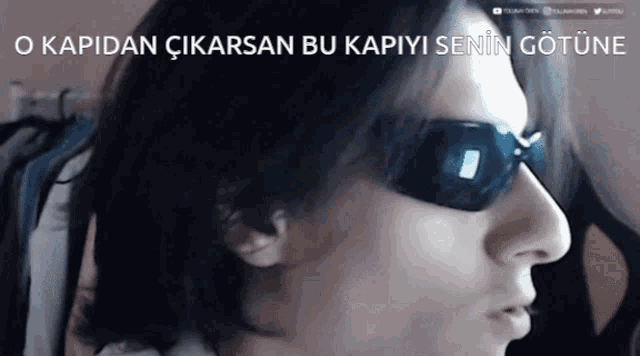 a close up of a person wearing sunglasses with the caption o kapidan