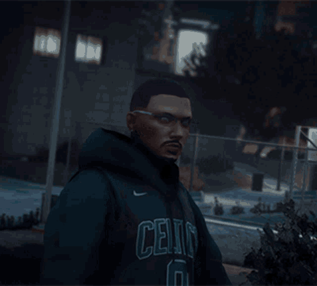 a man wearing a celtics hoodie is standing in front of a building