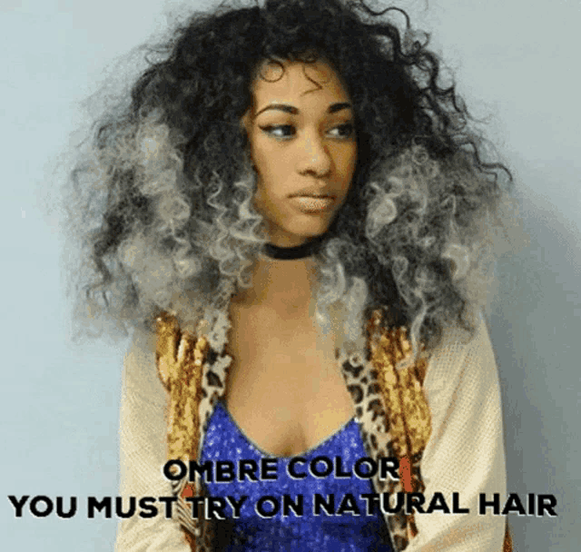a woman with curly hair is wearing a choker and a leopard print jacket ..