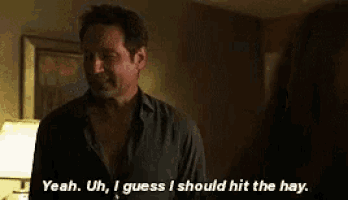 a man and a woman are standing next to each other in a dark room .