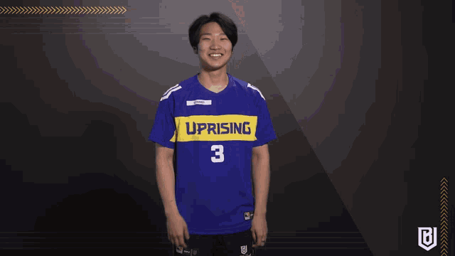 a man wearing a blue and yellow uprising jersey
