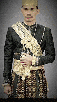 a man in a black and gold outfit holding a sword