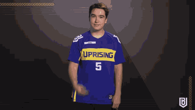 a young man wearing a blue uprising jersey number 5