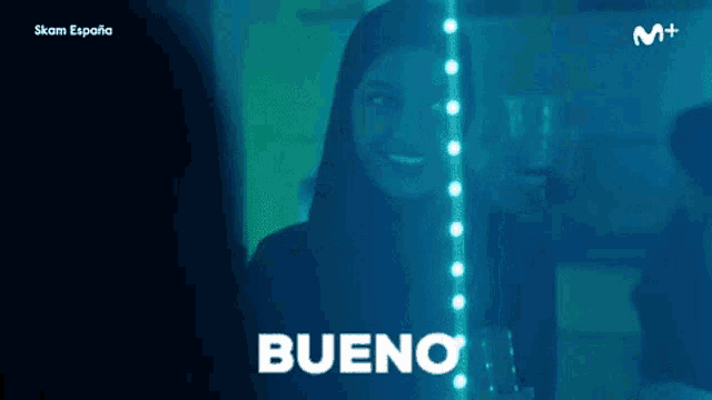 a woman wearing a hijab is smiling and the word bueno is on the bottom