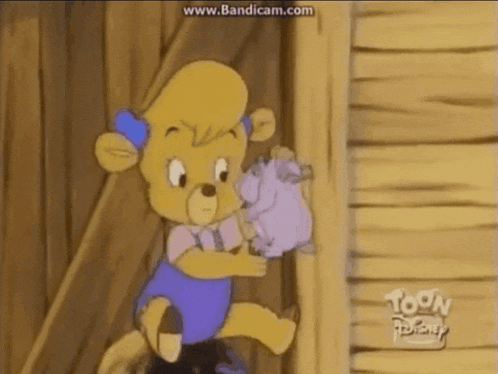 a cartoon character from toon disney is sitting on a wooden wall