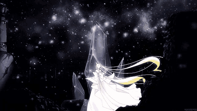 a woman in a white dress stands in front of a crystal in the dark