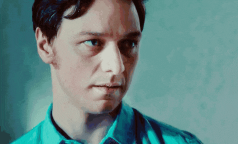 a close up of a man 's face with a blue shirt