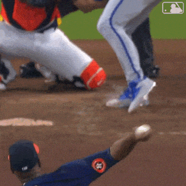 a baseball player throws a ball while wearing a blue jersey with the number 52 on it