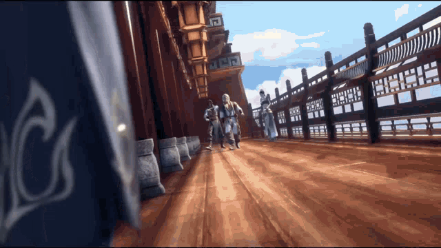 a group of people are walking on a wooden floor in a building