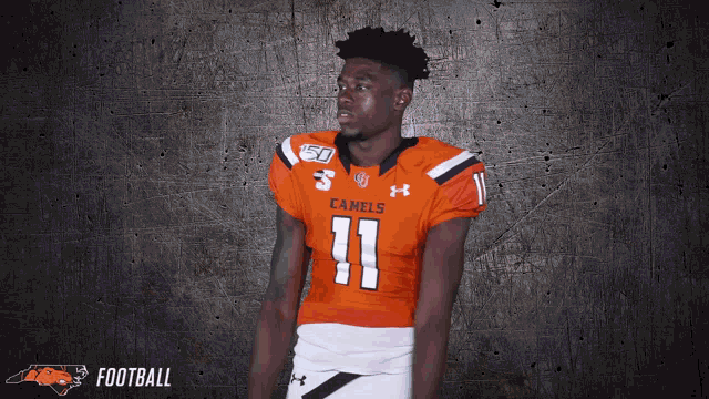 a football player wearing an orange uniform with the number 11 on it