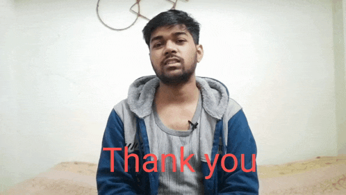 a man in a blue jacket says thank you in red letters