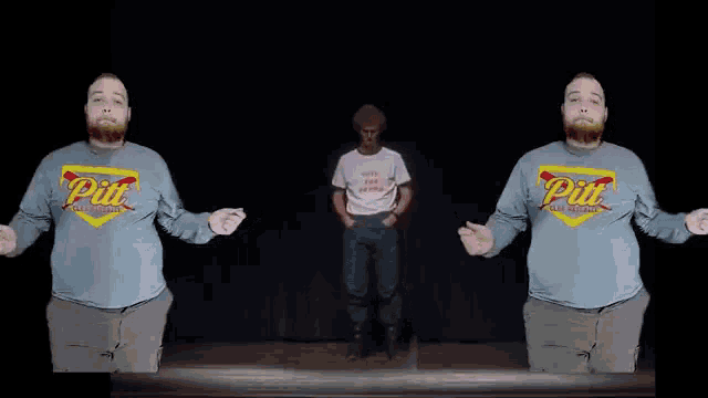 a man wearing a pit t-shirt stands next to another man