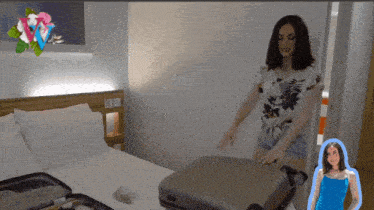 a woman in a blue dress is standing next to a suitcase in a hotel room
