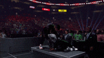 a snickers sign hangs above a crowd of people