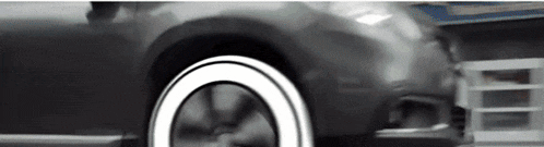a close up of a car wheel with a white tire